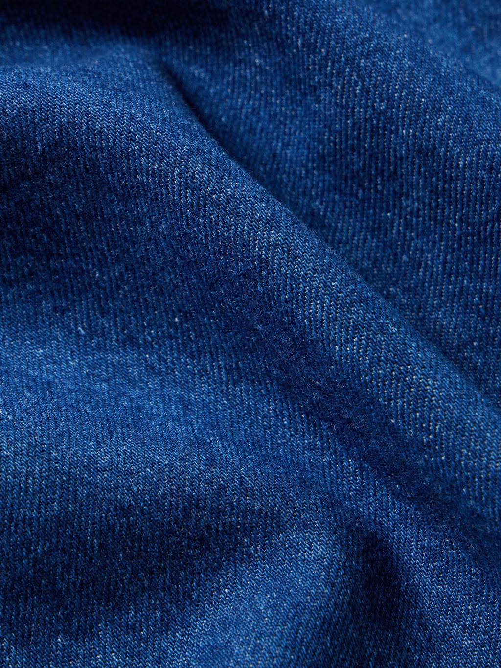 Dark indigo denim snap shirt fabric texture close-up
