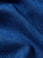 Dark indigo denim snap shirt fabric texture close-up