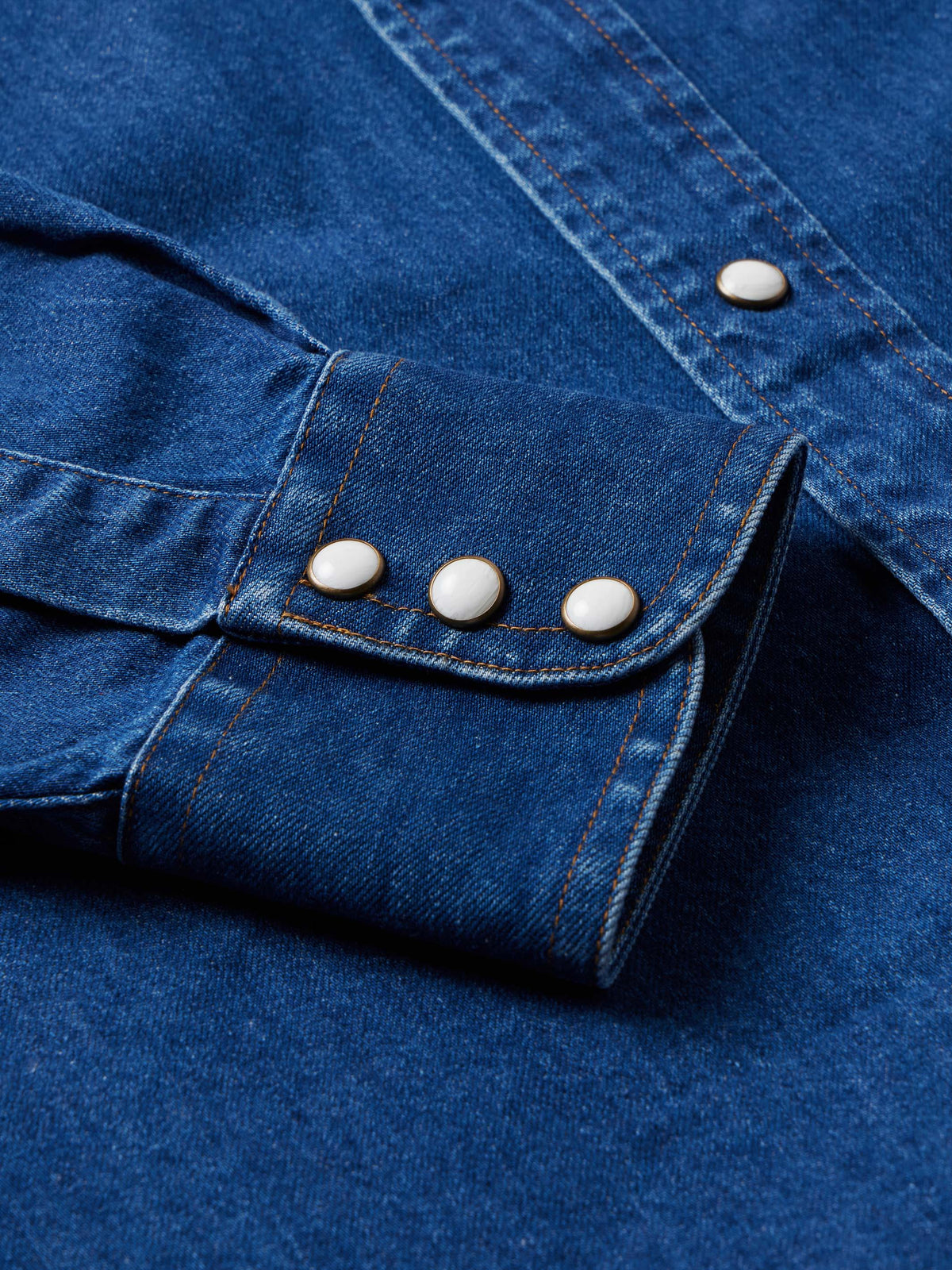 Dark indigo denim snap shirt with snapped cuffs and three-button placket