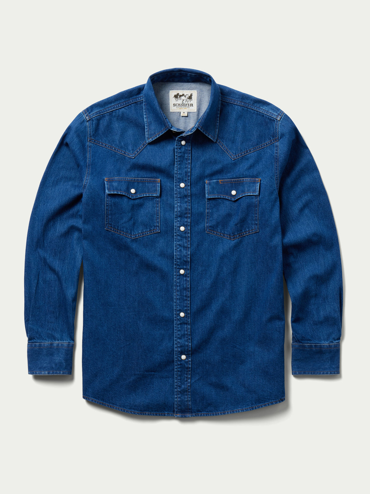 Dark indigo denim snap shirt, front view with two chest pockets
