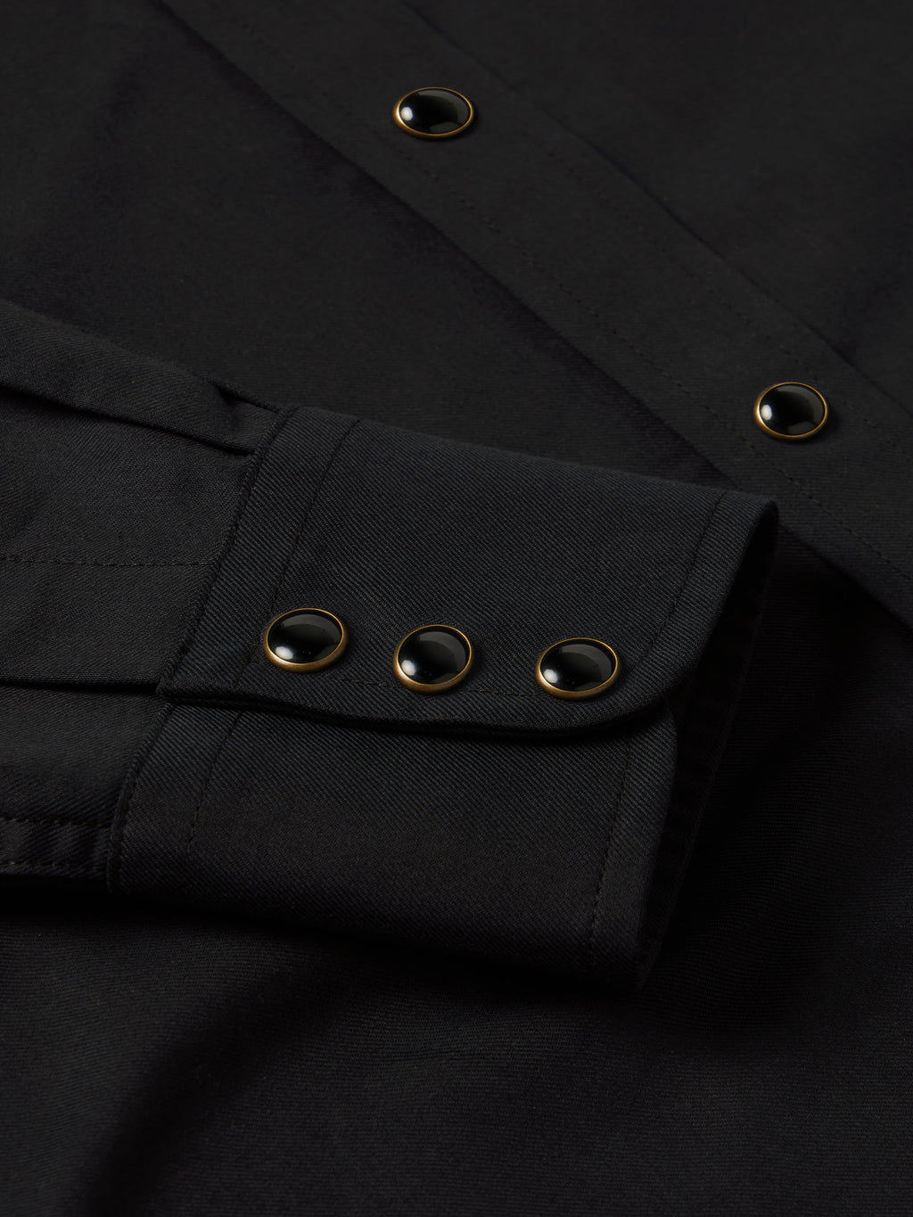Black western shirt placket with snap buttons and long sleeves