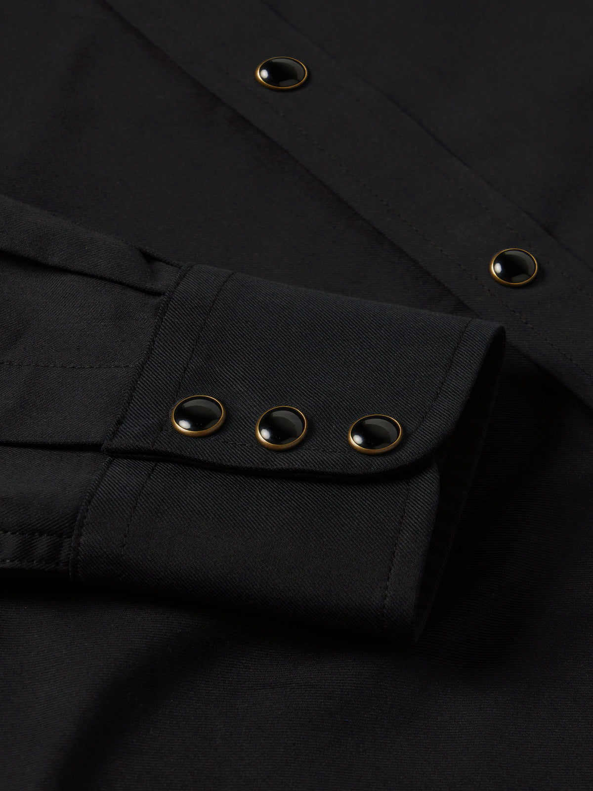Black western shirt placket with snap buttons and long sleeves