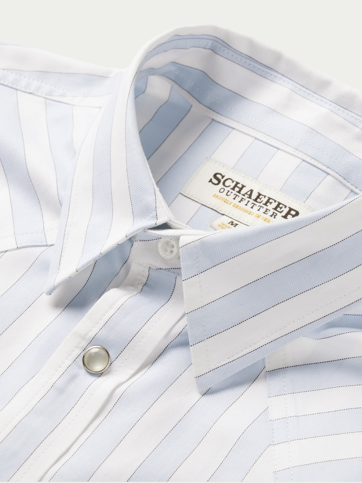 Light blue striped button-down shirt collar with snap placket and inner label