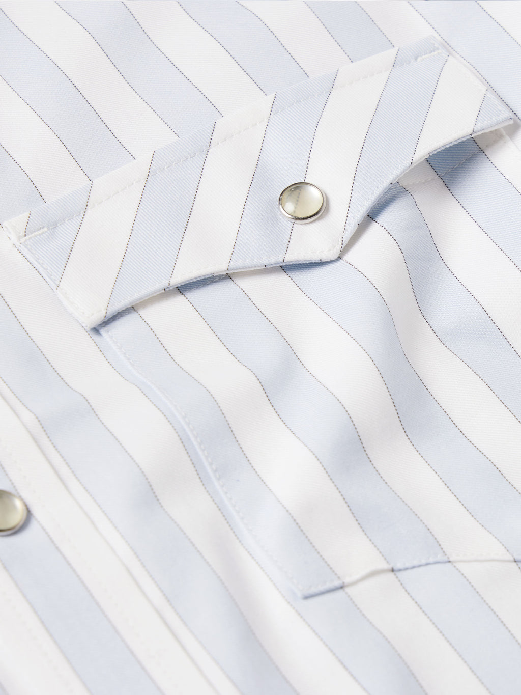 Light blue striped Western shirt cuff with snap button detail on fabric