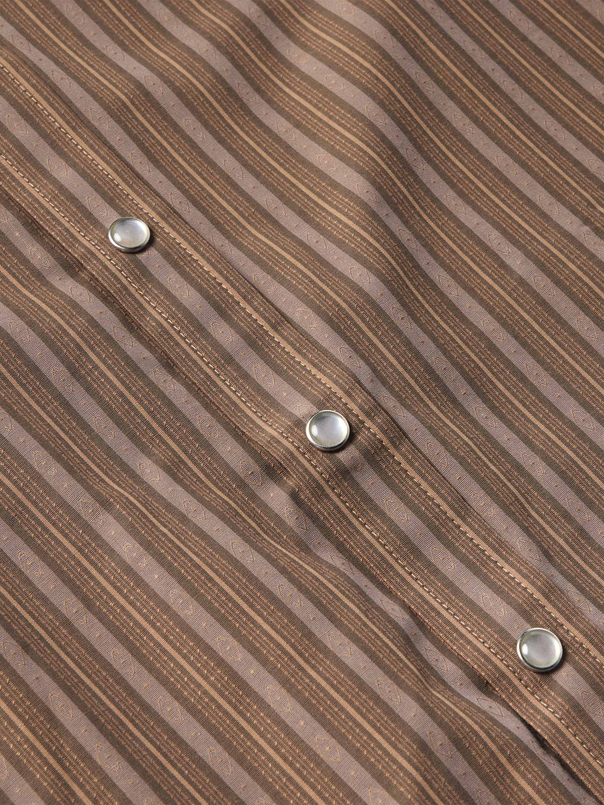 Western striped shirt front showing metal snap buttons along the placket