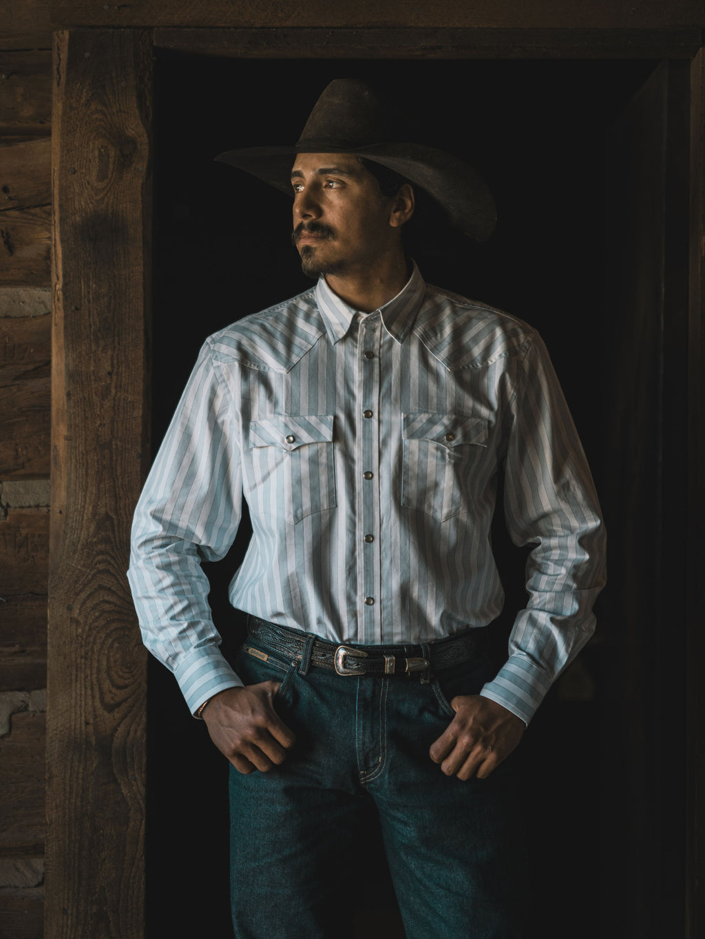 Light blue striped Western button-down shirt on model with snap cuffs