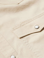 Khaki slub twill shirt cuff with snap closure and contrast stitching