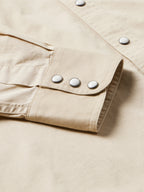 Light beige shirt cuff with three snap buttons