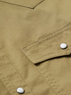 Olive slub twill shirt with snap cuff and visible stitched seam details