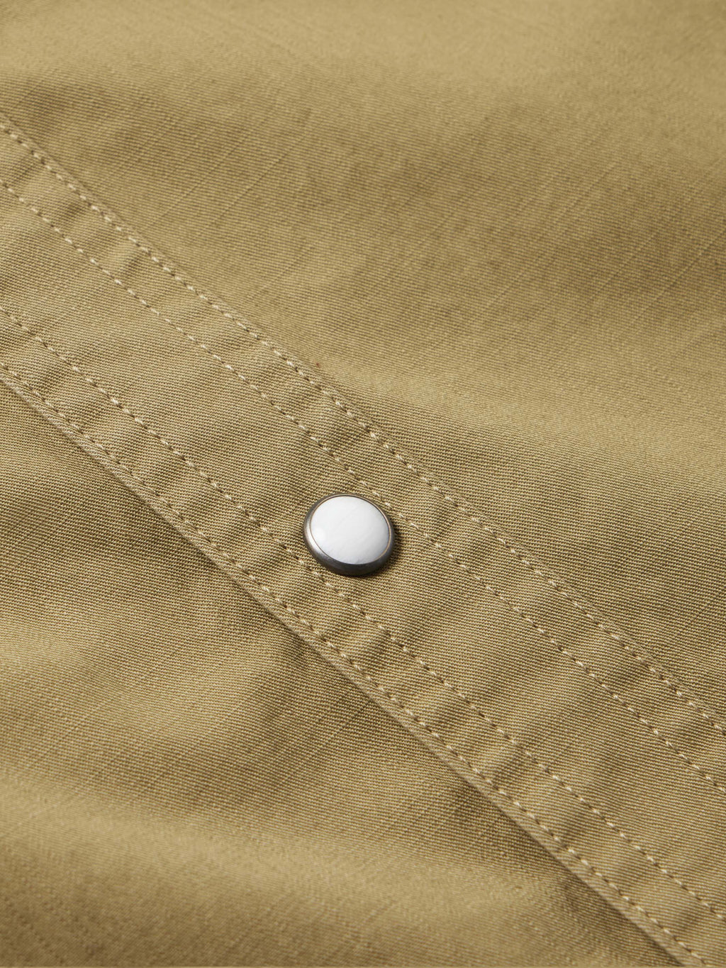 Olive slub twill shirt showing snap closure on stitched cuff placket