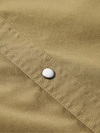 Olive slub twill shirt showing snap closure on stitched cuff placket