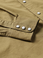 Olive slub twill shirt cuff with multiple snaps and elastic hem detail