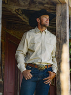 Light cream western-style button-up shirt with snap cuffs and chest pockets