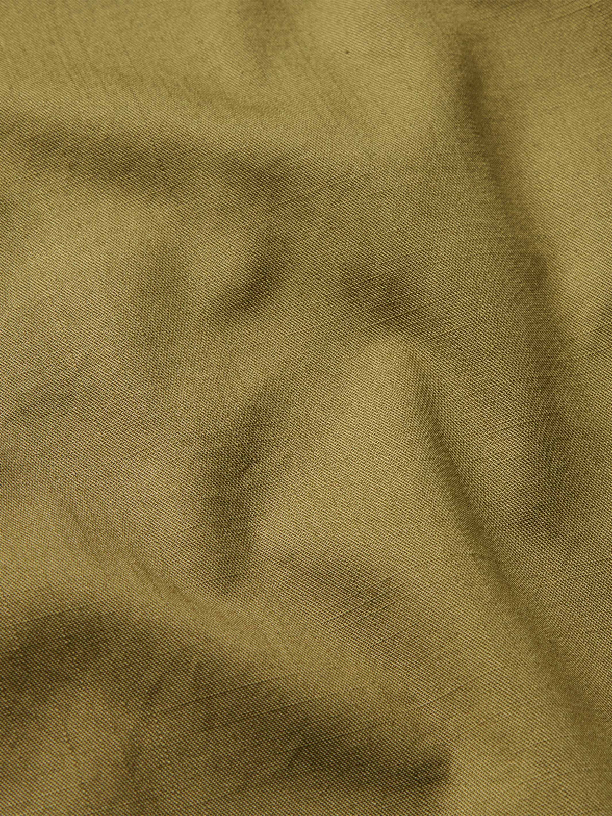Olive slub twill fabric close-up with subtle slub texture