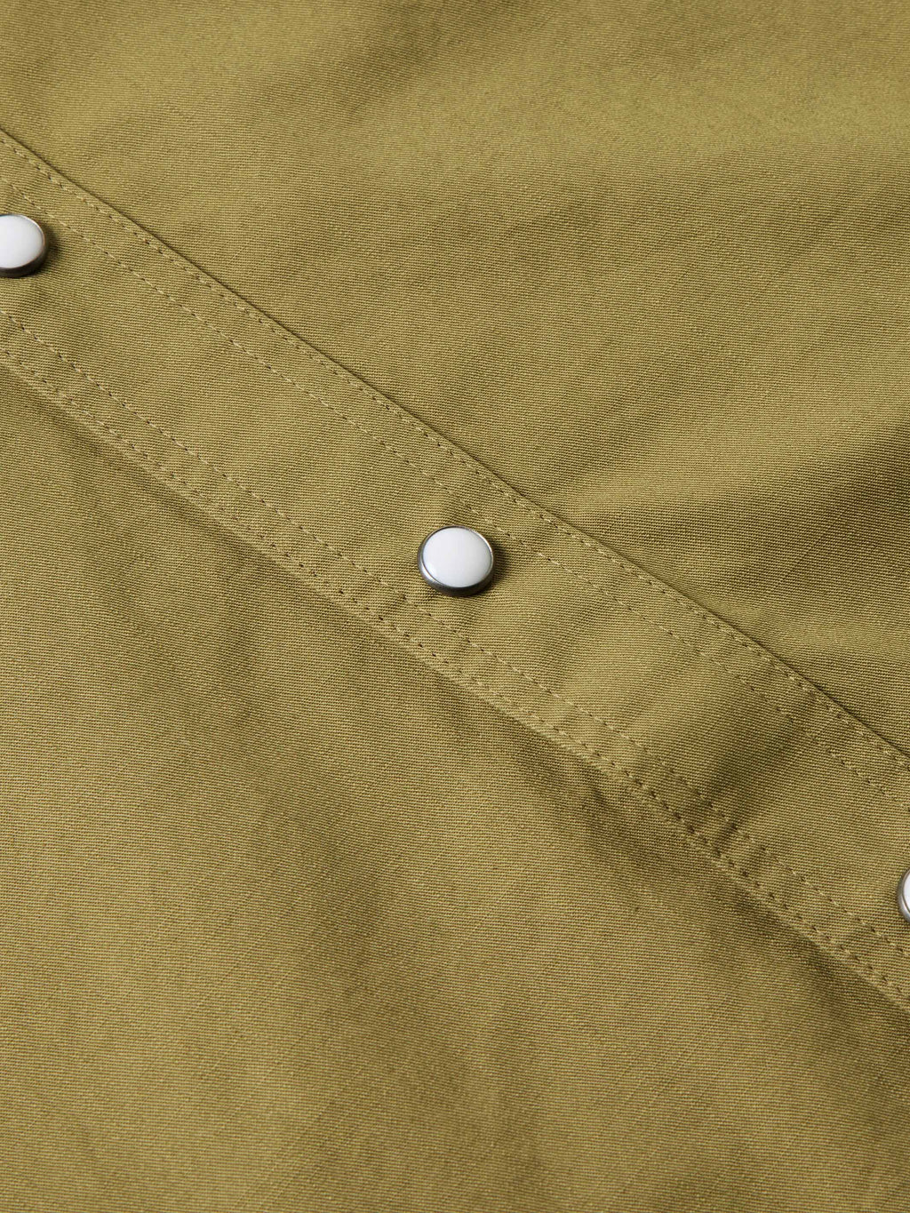 Olive slub twill placket with white snap buttons and visible stitching