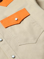 Quail shirt front pocket with orange patch tab and snap button closure