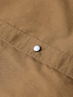 Walnut slub twill shirt fabric with a small white snap button