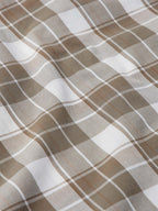 Close-up of tan and white plaid weave with soft fabric folds