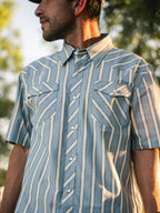 Blue and white striped short-sleeve pearl snap shirt with chest pockets and collar