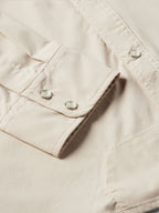 Khaki shirt cuff and sleeve placket with two button snaps and stitched trim