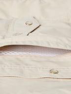 Khaki snap shirt pocket flap detail with metal ring snap and inner fabric lining