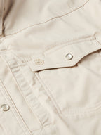 Khaki snap shirt chest pocket placket with embroidered emblem and metal snap button