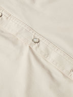 Khaki snap-front western shirt with metal button placket and stitching.