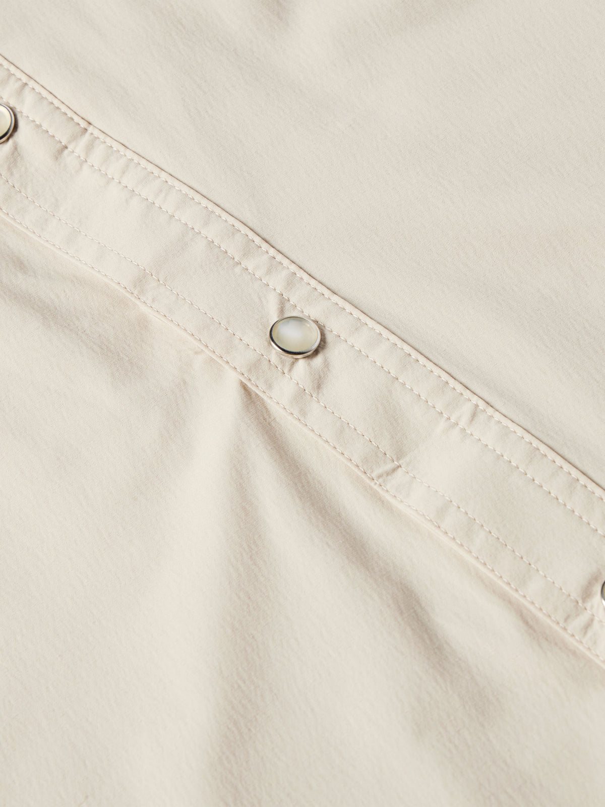 Khaki snap-front western shirt with metal button placket and stitching.