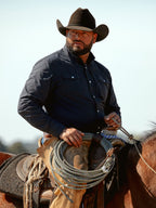 Black western snap shirt on a person, long sleeves with button-front closure