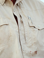 Khaki western snap shirt showing chest pocket and buttoned placket.