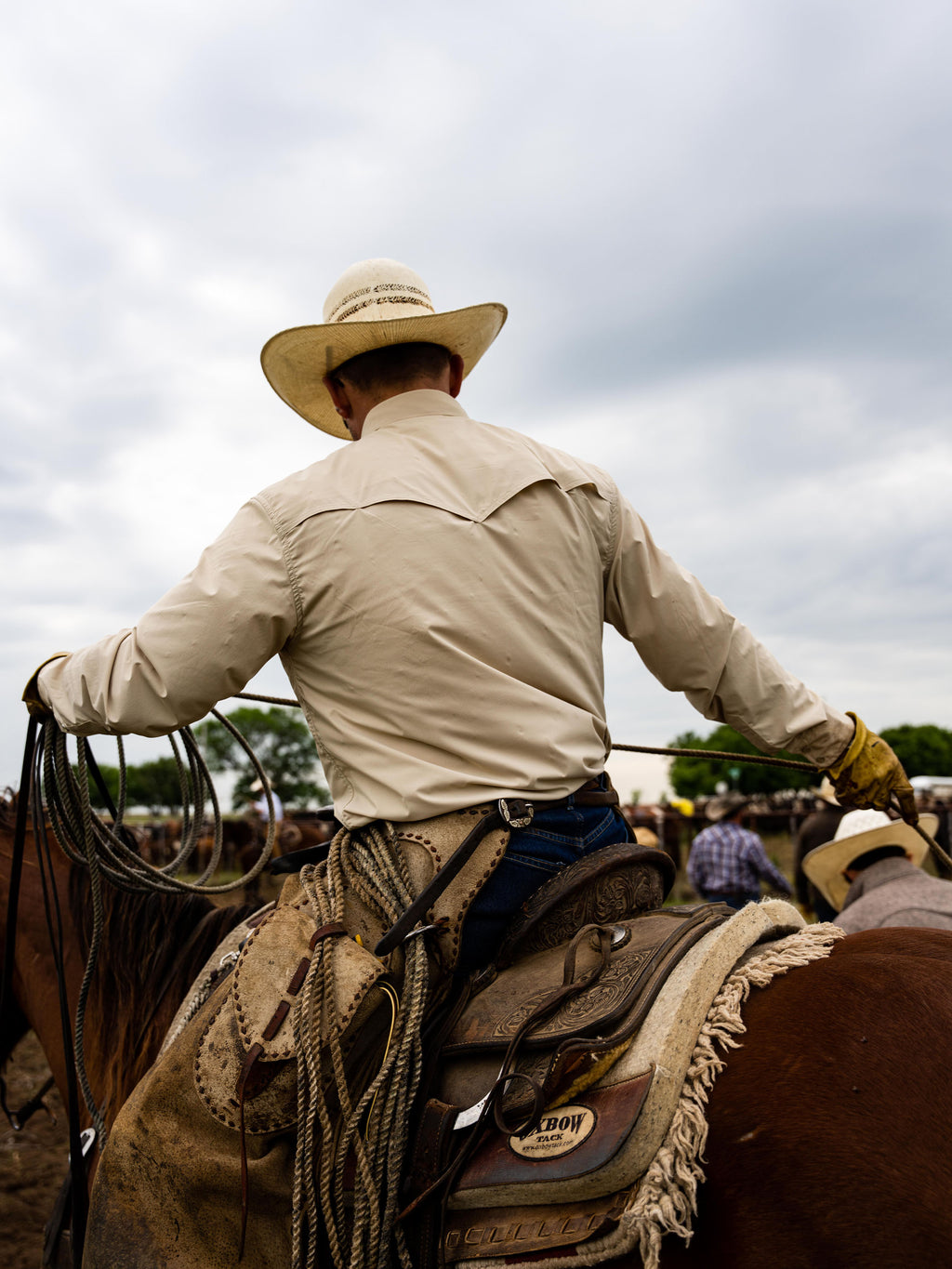 Khaki western snap shirt, back view showing yoke and shoulder seams.
