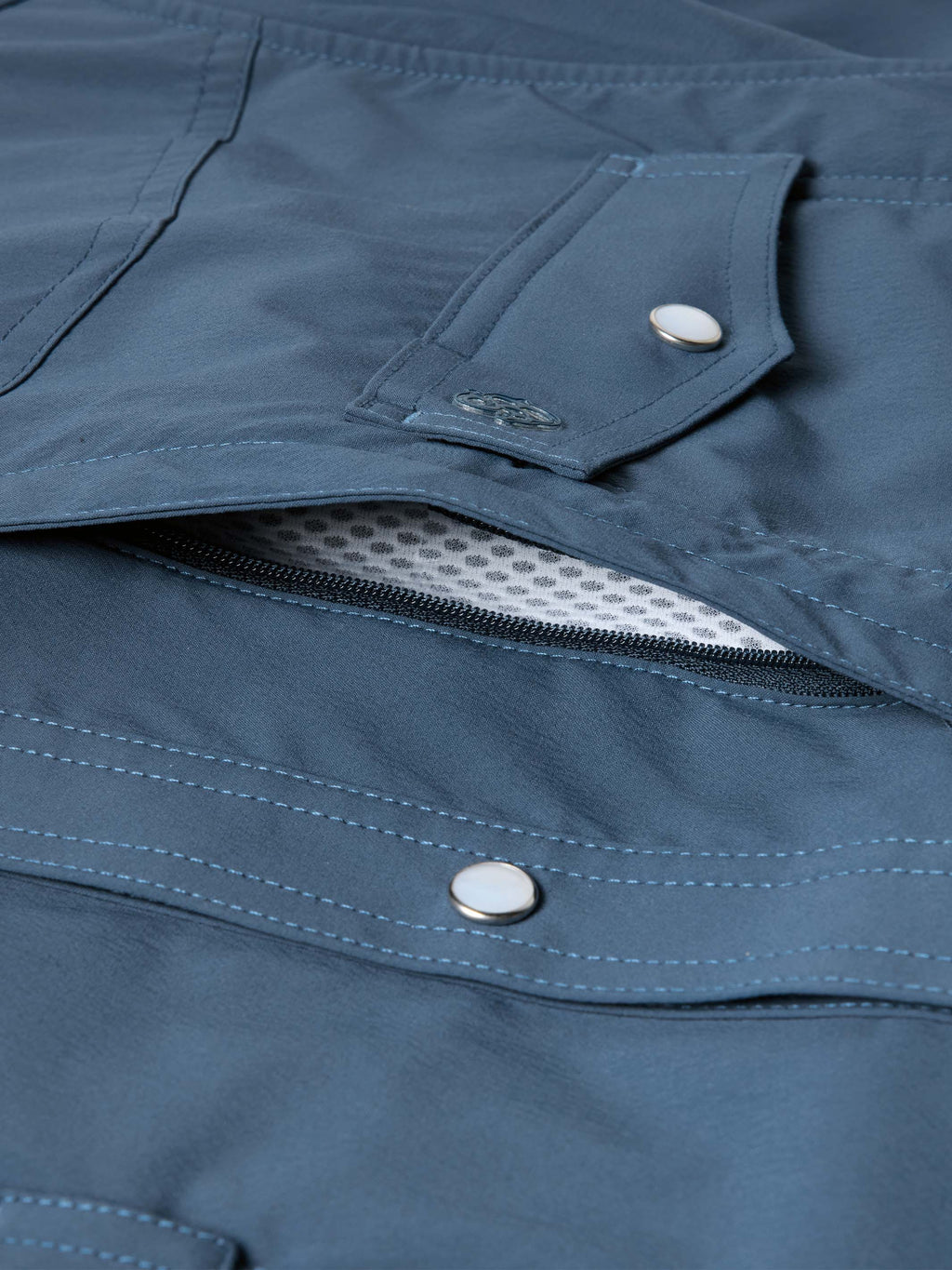 Navy snap pocket shirt with hidden zipper and flap closure