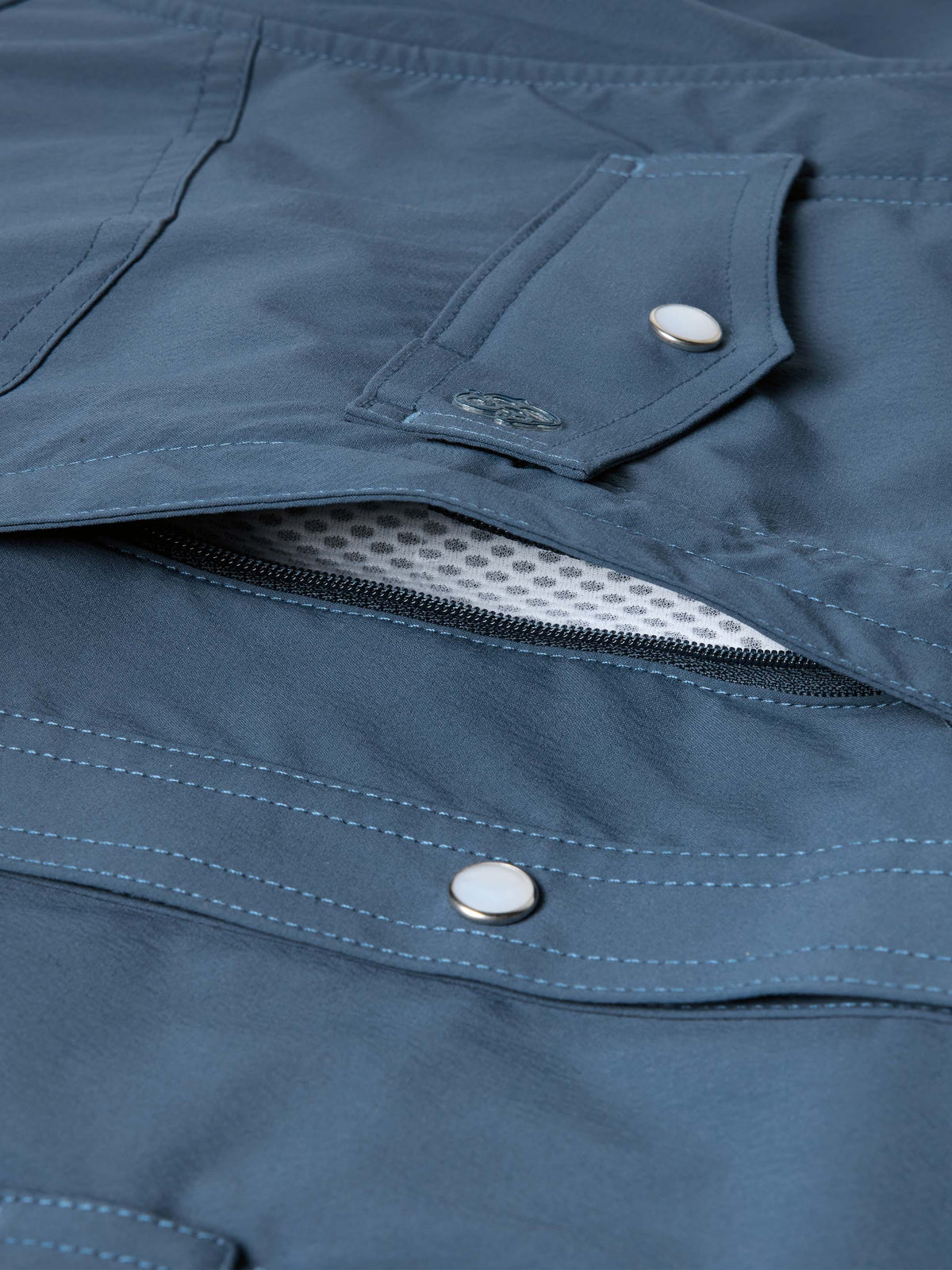 Navy snap pocket shirt with hidden zipper and flap closure