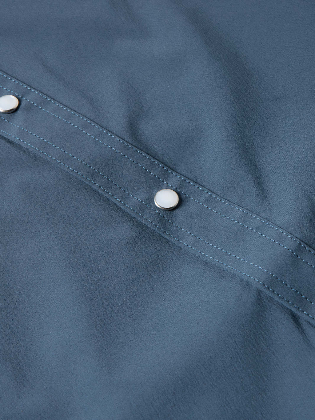 Navy western snap shirt with contrast-stitched seam and silver button