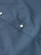 Navy western snap shirt with contrast-stitched seam and silver button