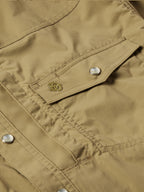 Olive snap-front western guide shirt detail: chest pocket flap with metal snap