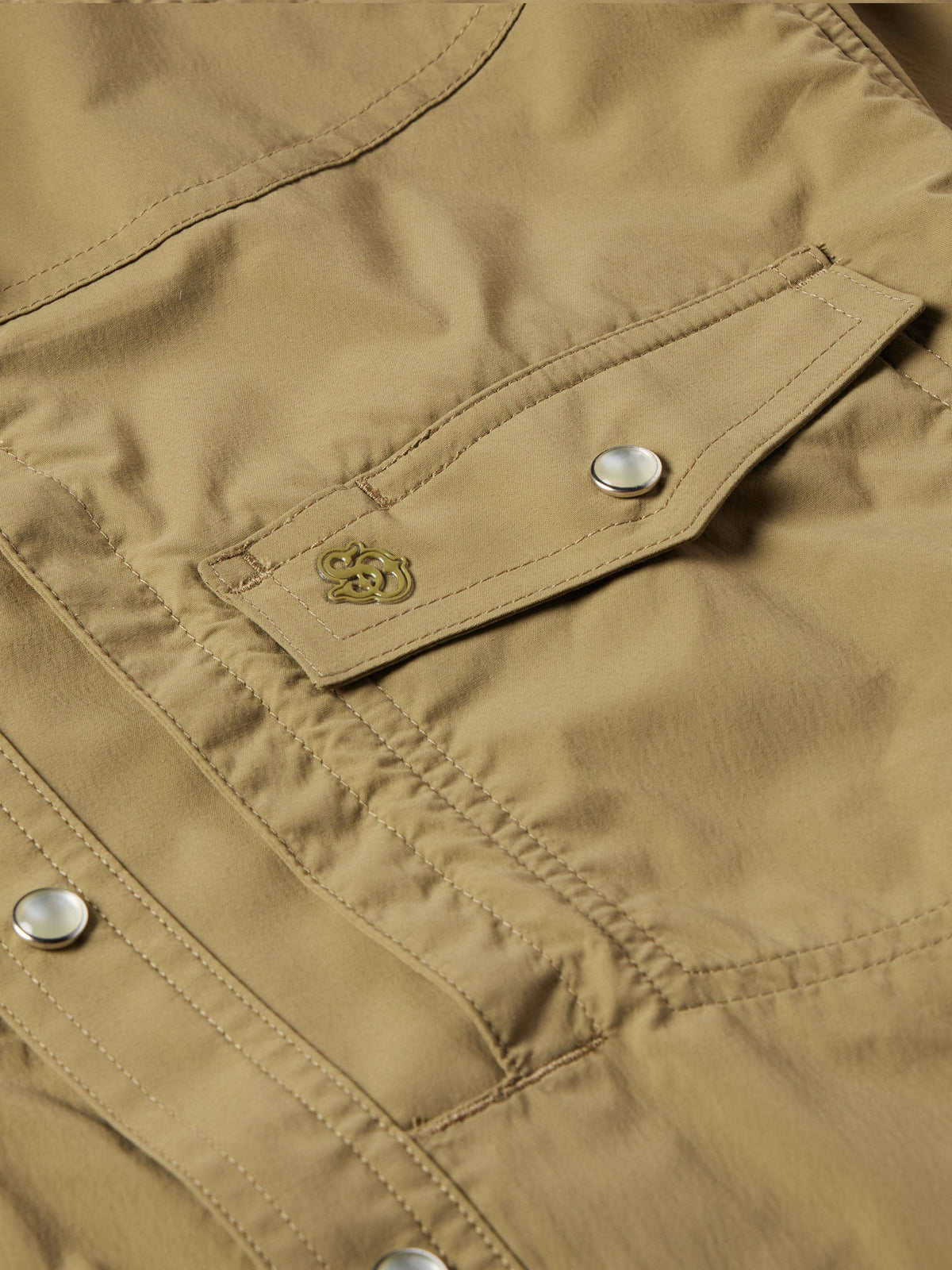Olive snap-front western guide shirt detail: chest pocket flap with metal snap