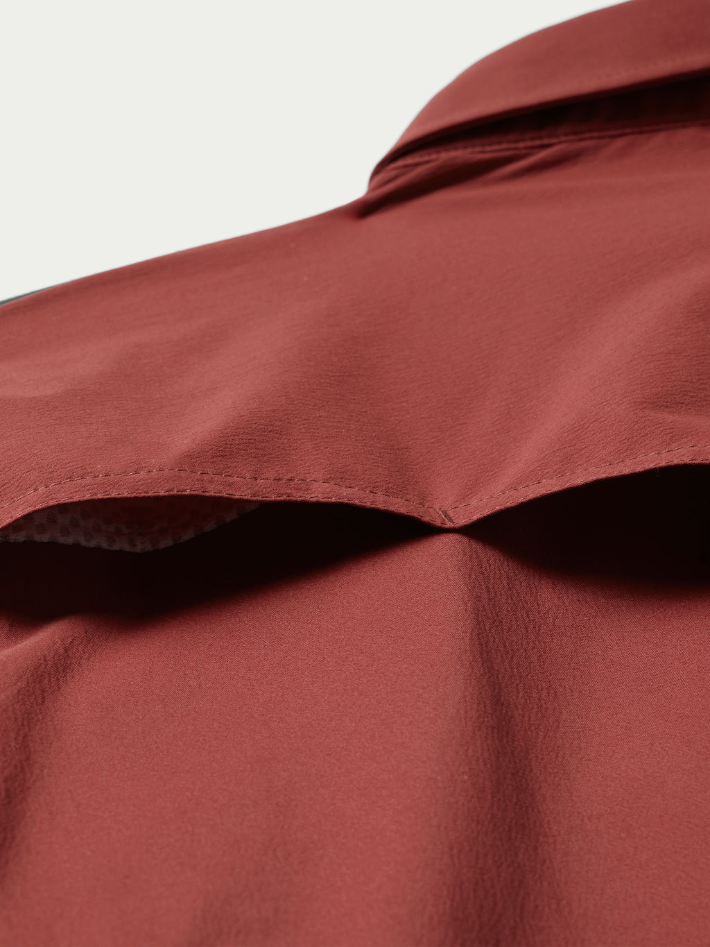 Oxblood shirt collar and shoulder with smooth fabric and structured seam