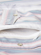 Pocket edge and snaps close-up on pastel striped western snap shirt with embroidered logo
