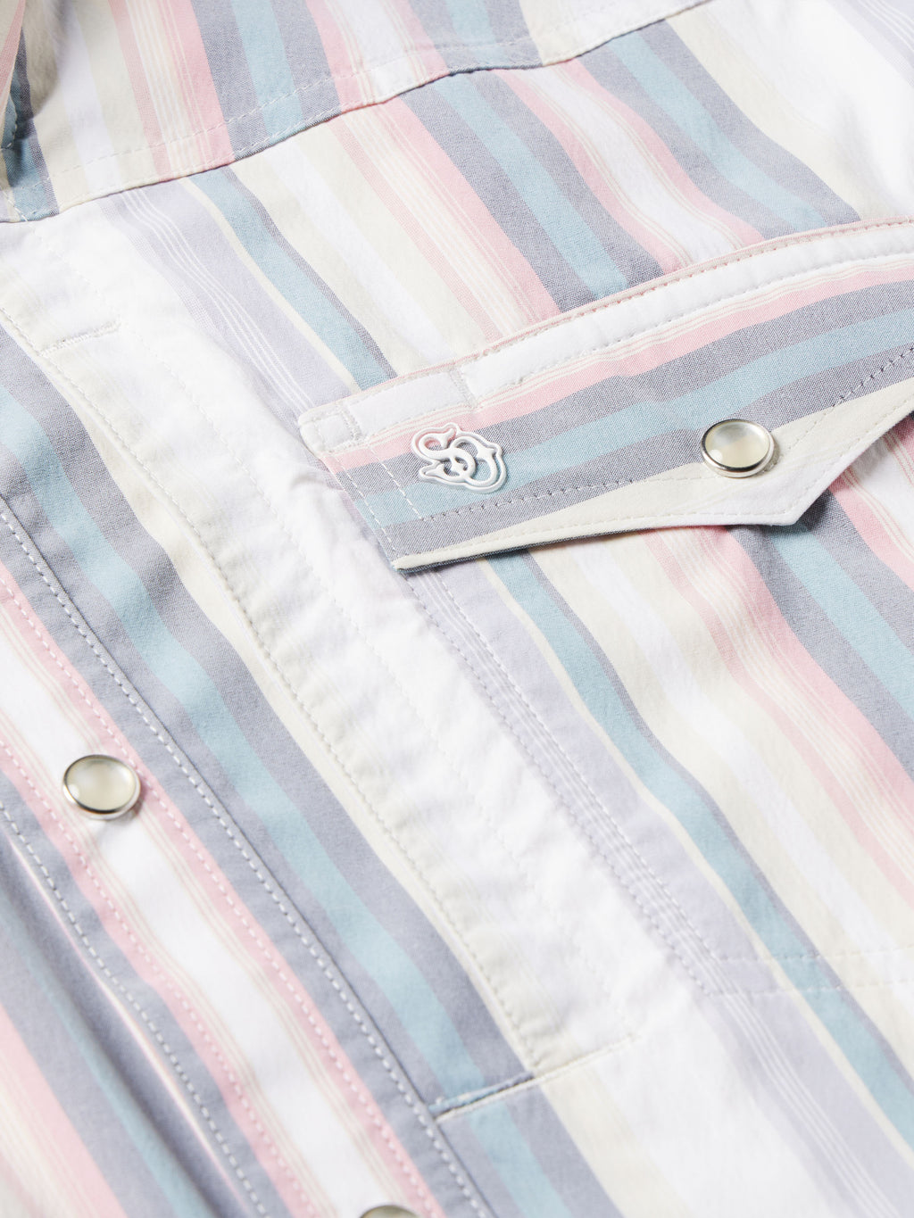 Front pocket flap close-up on pastel striped western snap shirt with snap buttons