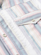 Front pocket flap close-up on pastel striped western snap shirt with snap buttons