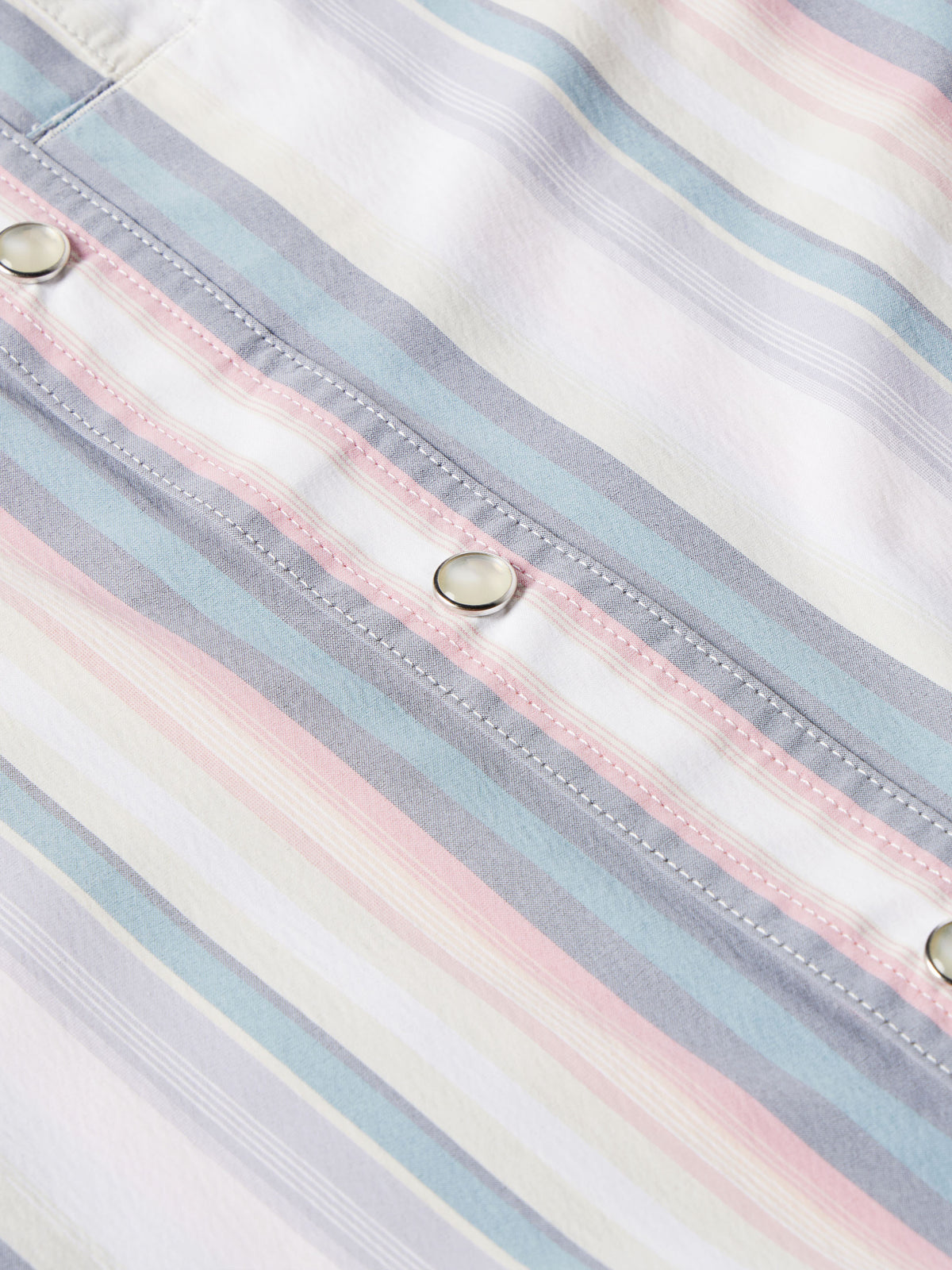 Detail of side seam and snap placket on pastel striped western snap shirt