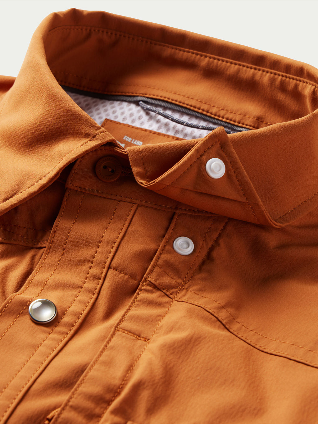 Rust western snap shirt with collar, snap buttons, and inner label