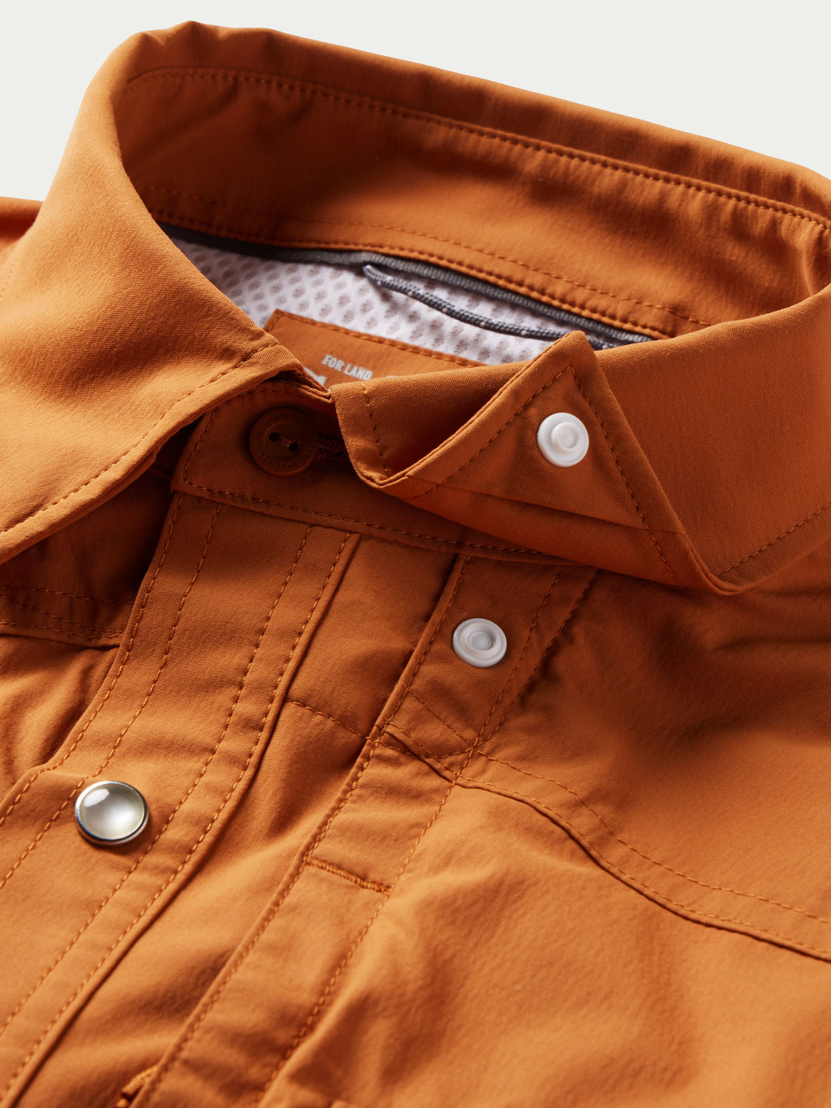 Rust western snap shirt with collar, snap buttons, and inner label