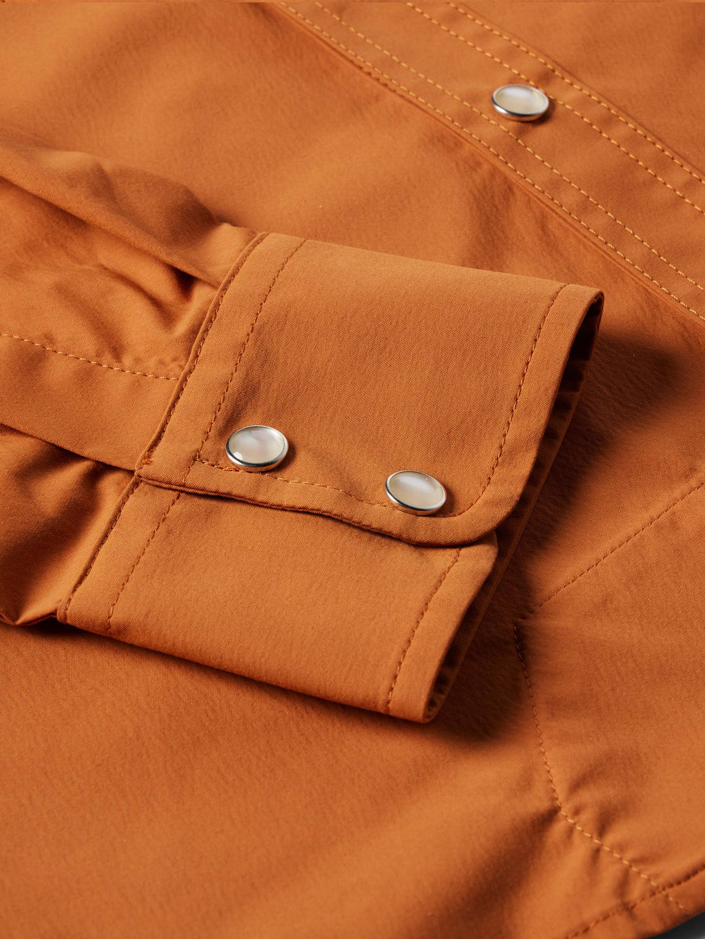 Rust western snap shirt cuff with silver snap buttons