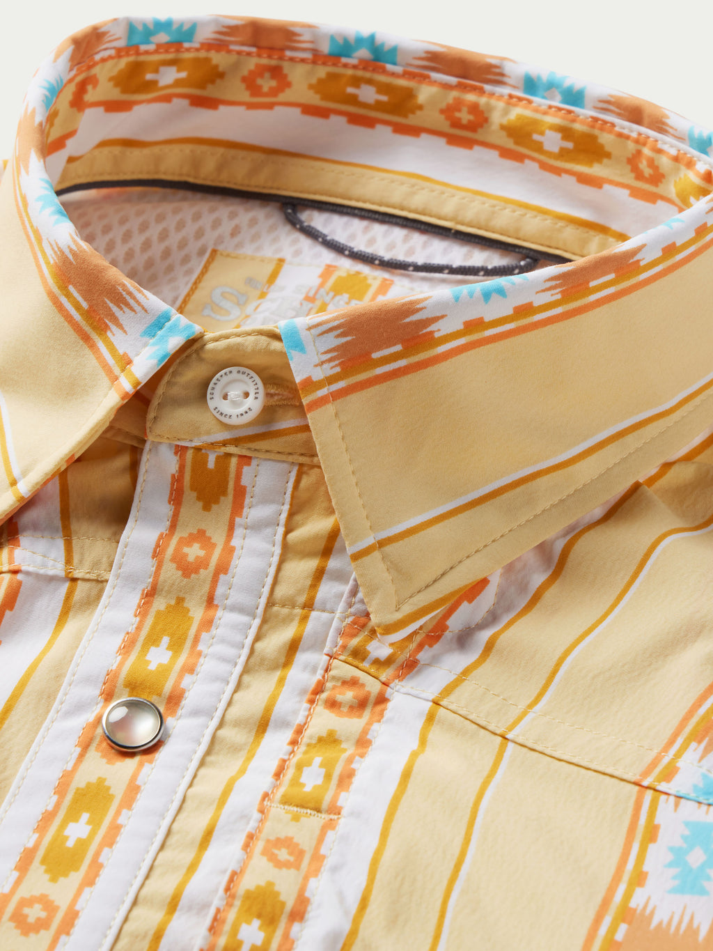 Western snap shirt collar and placket with cream fabric, orange trim, and Aztec pattern