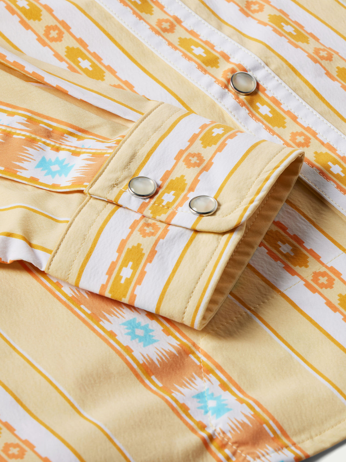 Western snap shirt cuff and front placket with metal snaps in cream and orange Aztec stripes