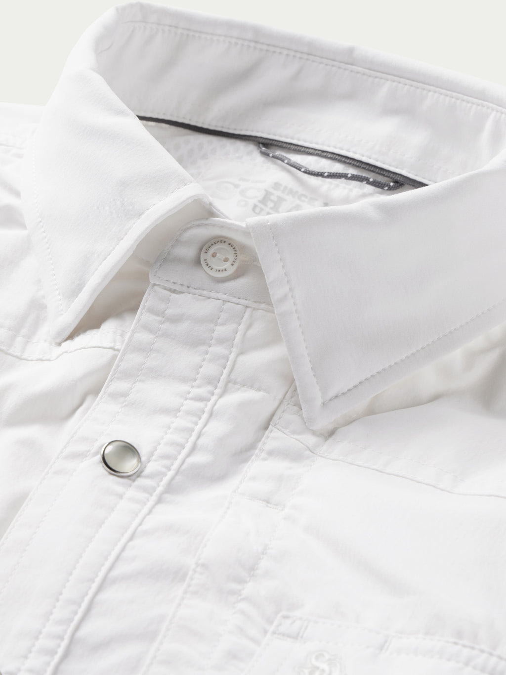 White western snap shirt chest placket with snap button and top-stitching close-up