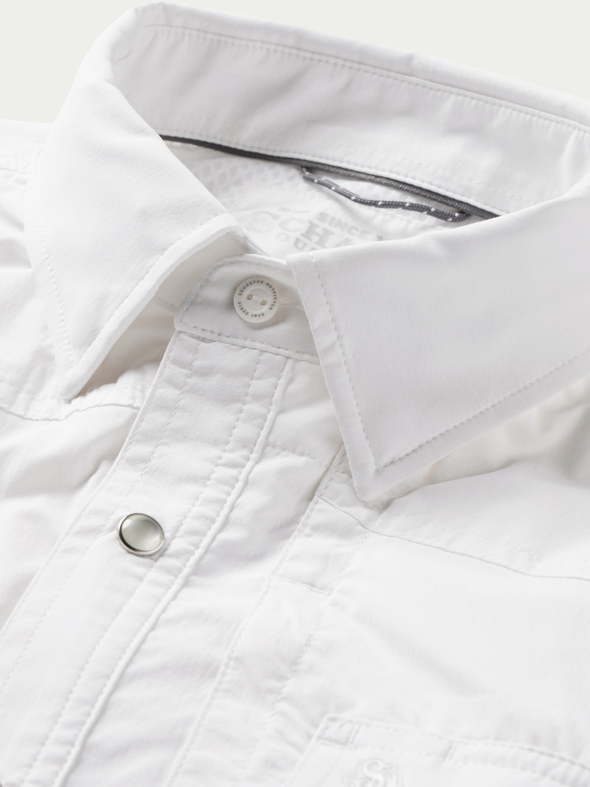 White western snap shirt chest placket with snap button and top-stitching close-up