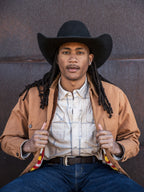 Western guide snap shirt on model, tan with light blue plaid, snap front and pockets.